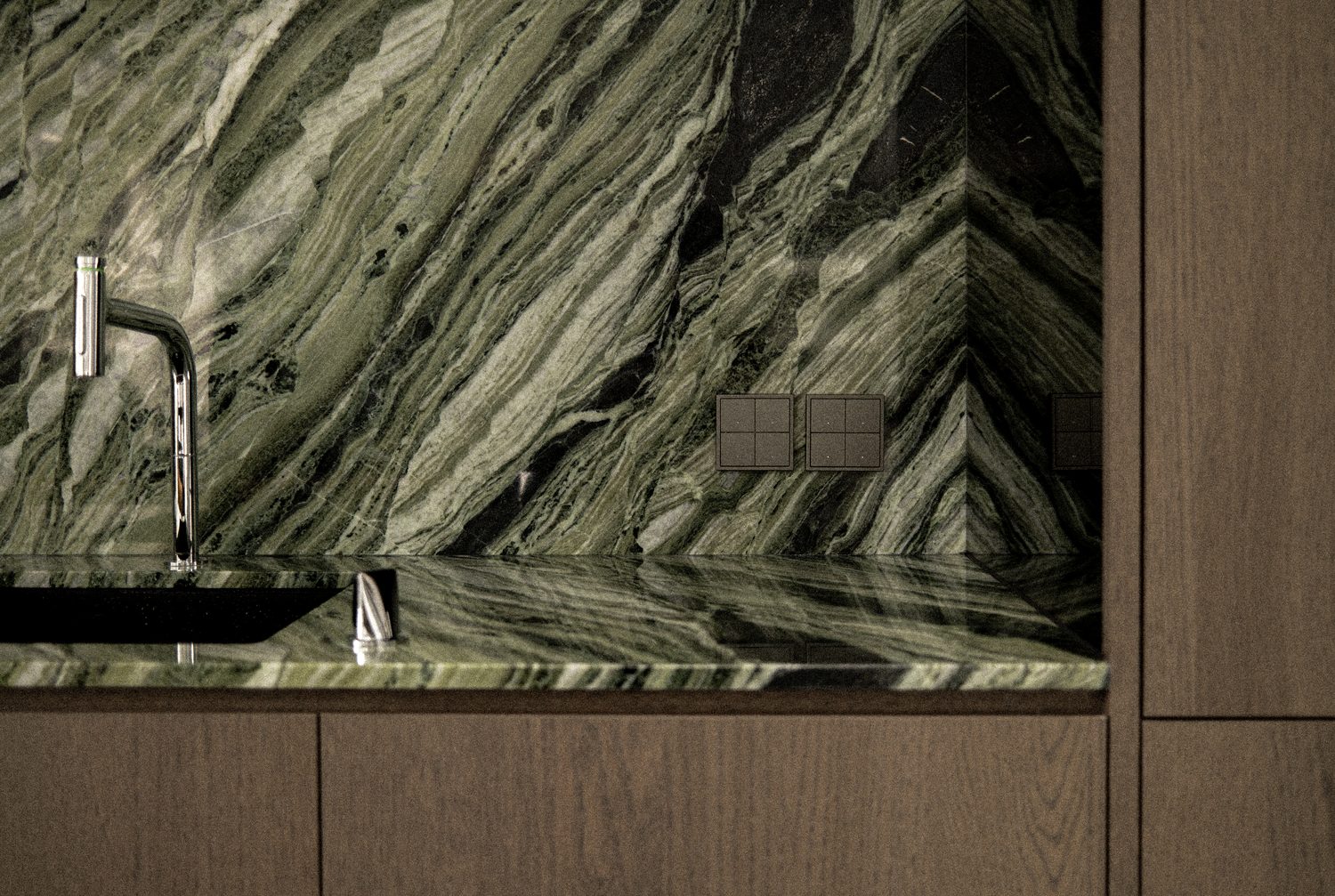 The kitchen — a green-marble counter and splashback with a polished chrome tap