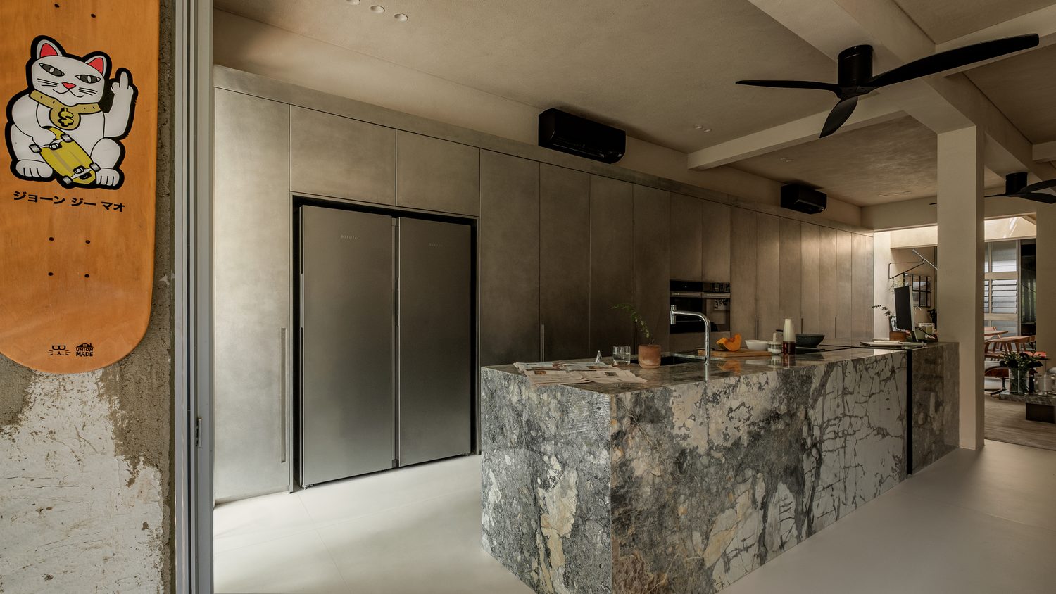The kitchen — a veined grey marble island against pewter cabinetry