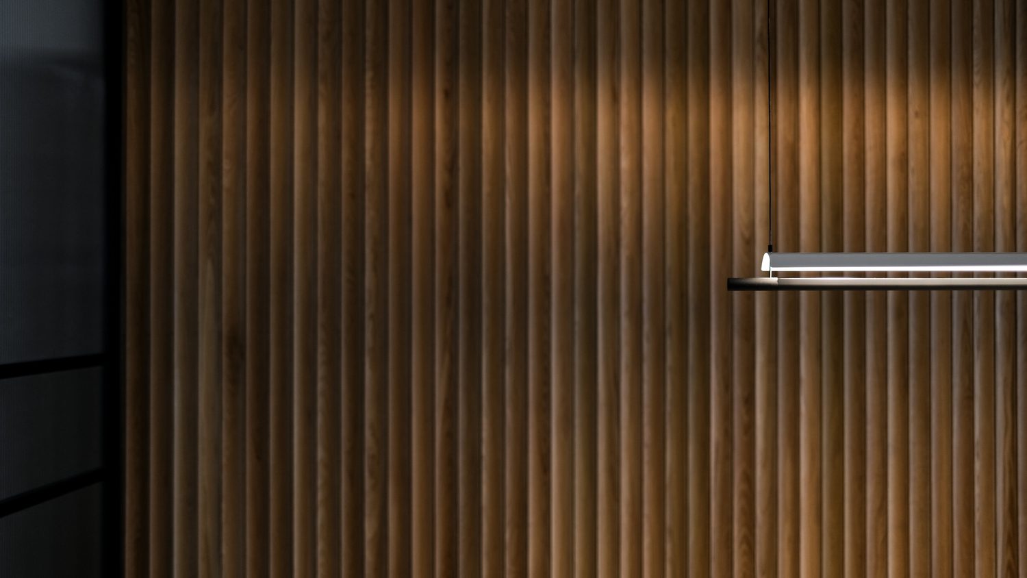 A wall of timber battens grazed by a single linear pendant